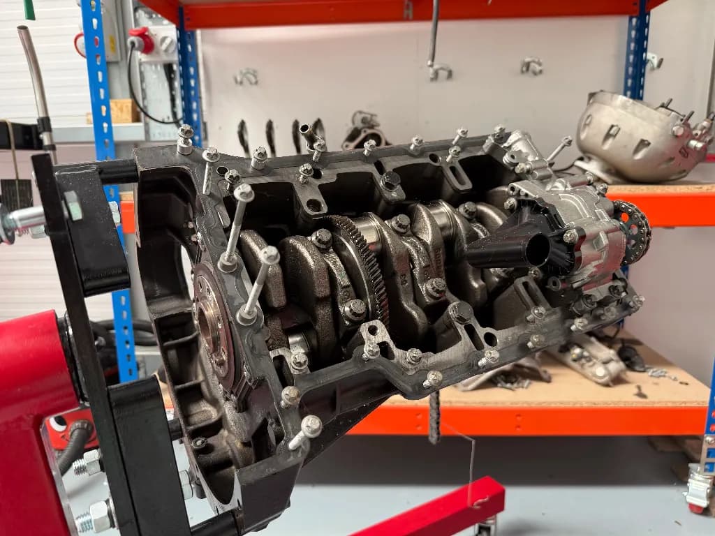 An aircraft engine stripped down on a stand in the workshop